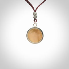 Hand made woolly mammoth tusk moon face necklace. Made by NZ Pacific and sale online only. Delivered with adjustable cord and packaged in a woven kete pouch.
