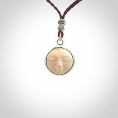 Hand made woolly mammoth tusk moon face necklace. Made by NZ Pacific and sale online only. Delivered with adjustable cord and packaged in a woven kete pouch.