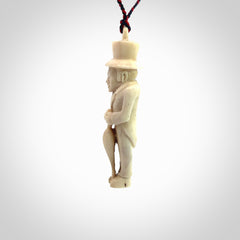 This unique contemporary hunchback with red pepper piece is hand carved in deer antler, bone and is a one off pendant. It is a delightful, large sized and artistic piece of jewellery. One only necklace. We provide this pendant on a blue and red adjustable cord.