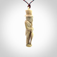 This unique contemporary hunchback with red pepper piece is hand carved in deer antler, bone and is a one off pendant. It is a delightful, large sized and artistic piece of jewellery. One only necklace. We provide this pendant on a blue and red adjustable cord.