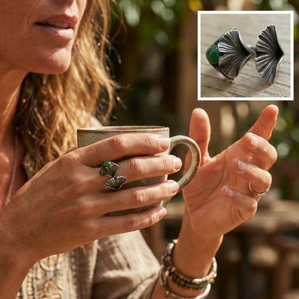 Woman holding a mug with a close-up of silver and jade ring