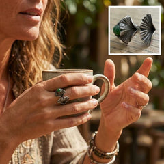 Woman holding a mug with a close-up of silver and jade ring