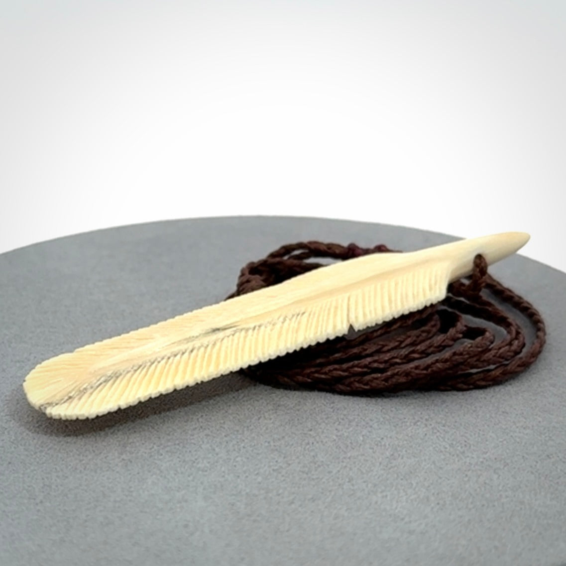 Hand carved Woolly Mammoth Tusk feather pendant. Art to Wear. Provided with adjustable cord.