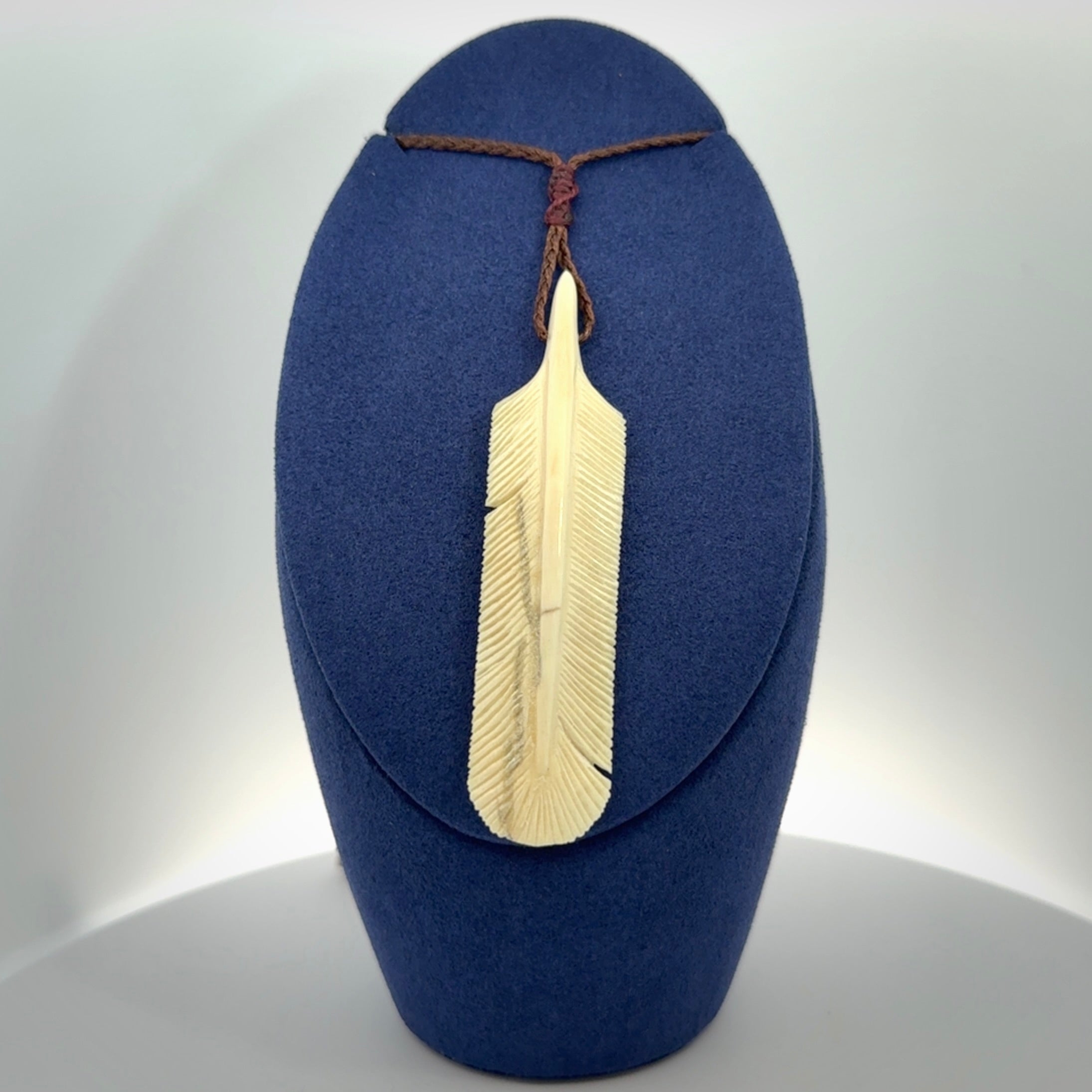 Hand carved Woolly Mammoth Tusk feather pendant. Art to Wear. Provided with adjustable cord.
