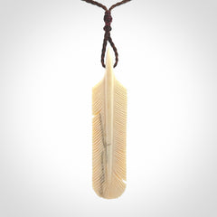 Hand carved Woolly Mammoth Tusk feather pendant. Art to Wear. Provided with adjustable cord.
