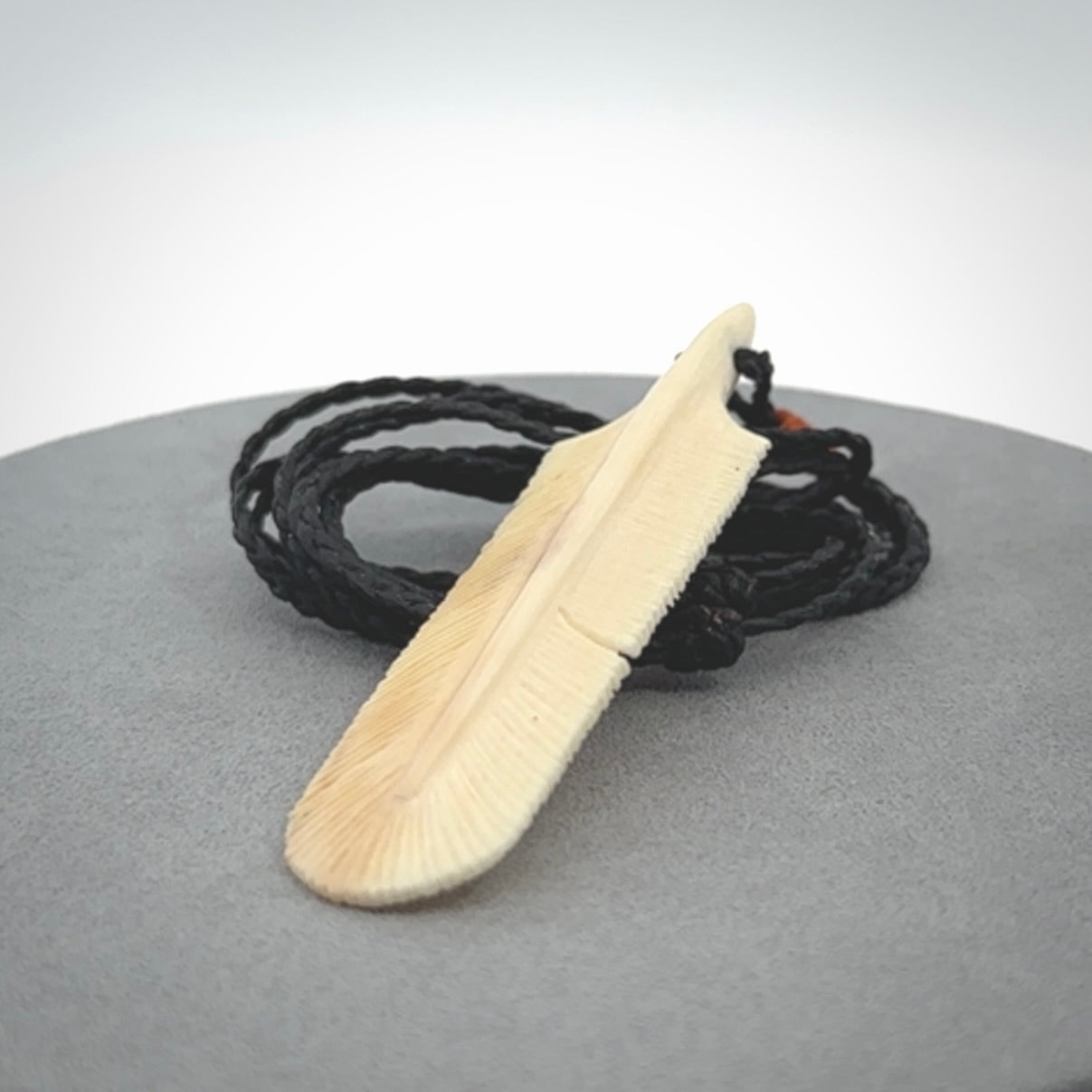 Hand carved Woolly Mammoth Tusk feather pendant. Art to Wear. Provided with adjustable cord.