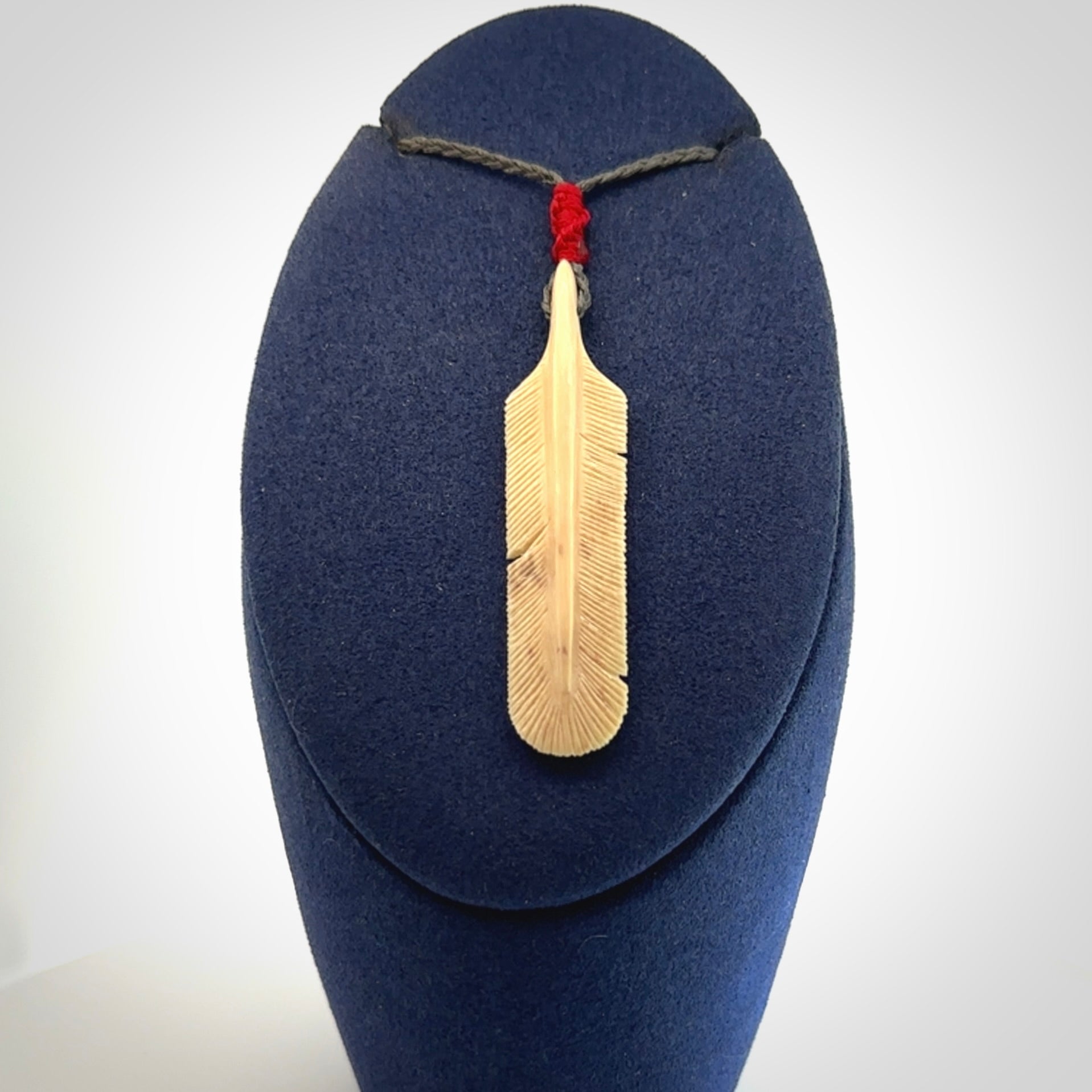 Hand carved Woolly Mammoth Tusk feather pendant. Art to Wear. Provided with adjustable cord.