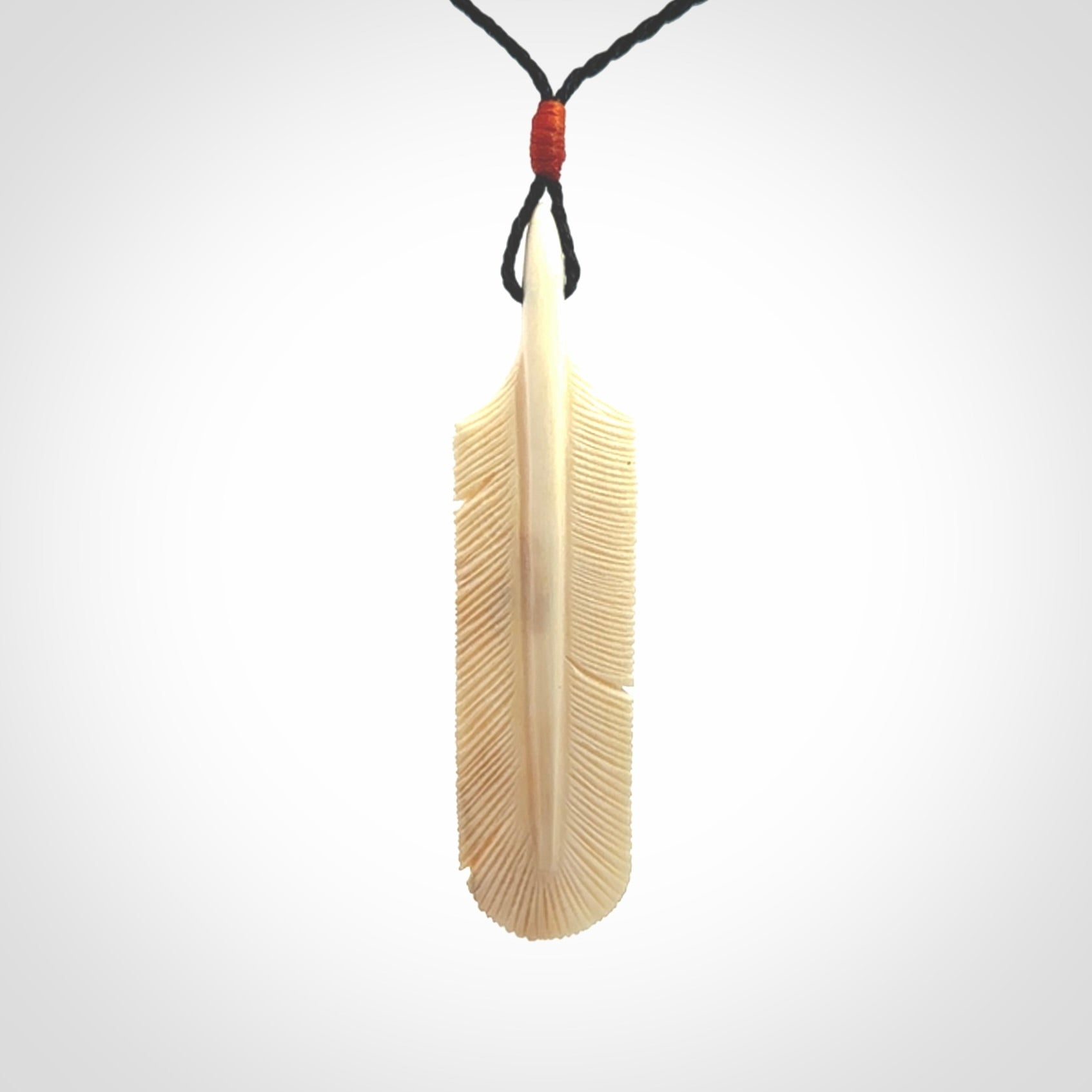 Hand carved Woolly Mammoth Tusk feather pendant. Art to Wear. Provided with adjustable cord.