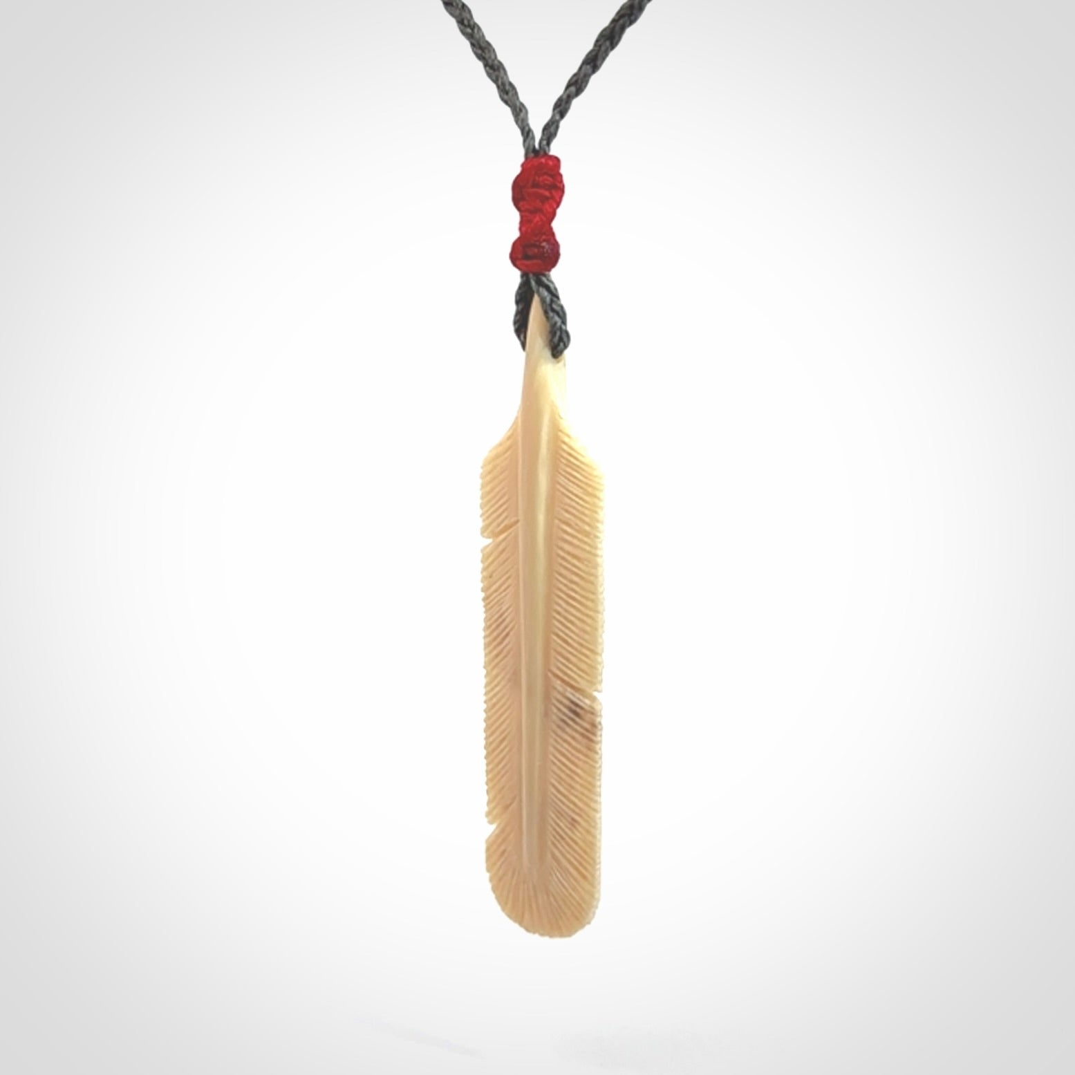 Hand carved Woolly Mammoth Tusk feather pendant. Art to Wear. Provided with adjustable cord.