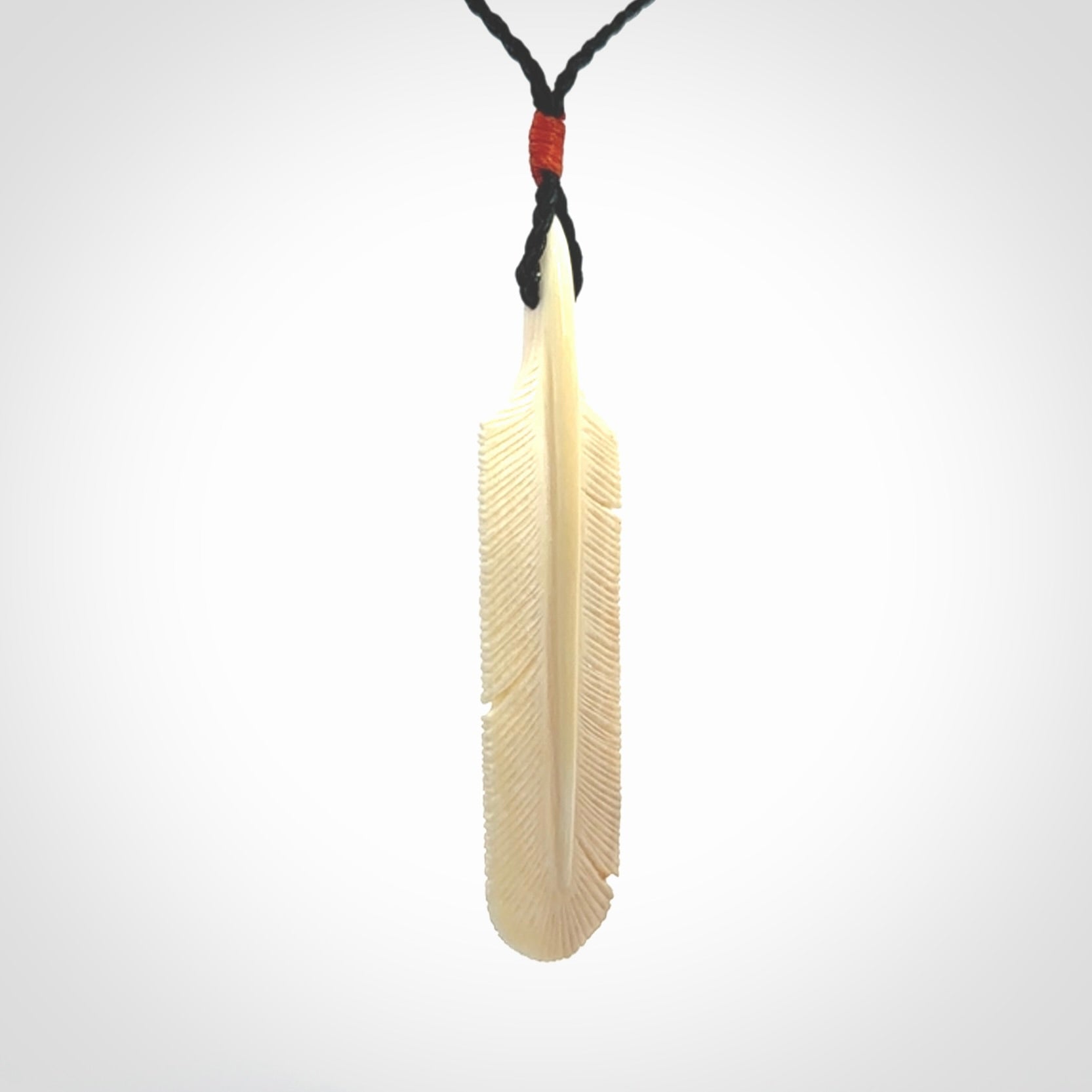 Hand carved Woolly Mammoth Tusk feather pendant. Art to Wear. Provided with adjustable cord.