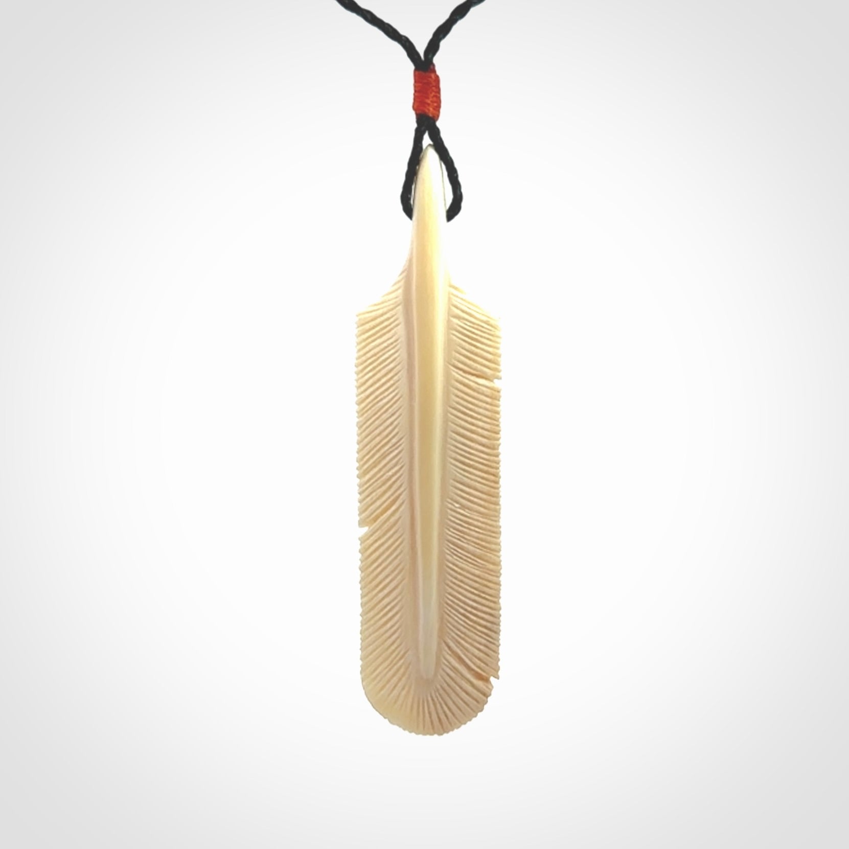 Hand carved Woolly Mammoth Tusk feather pendant. Art to Wear. Provided with adjustable cord.