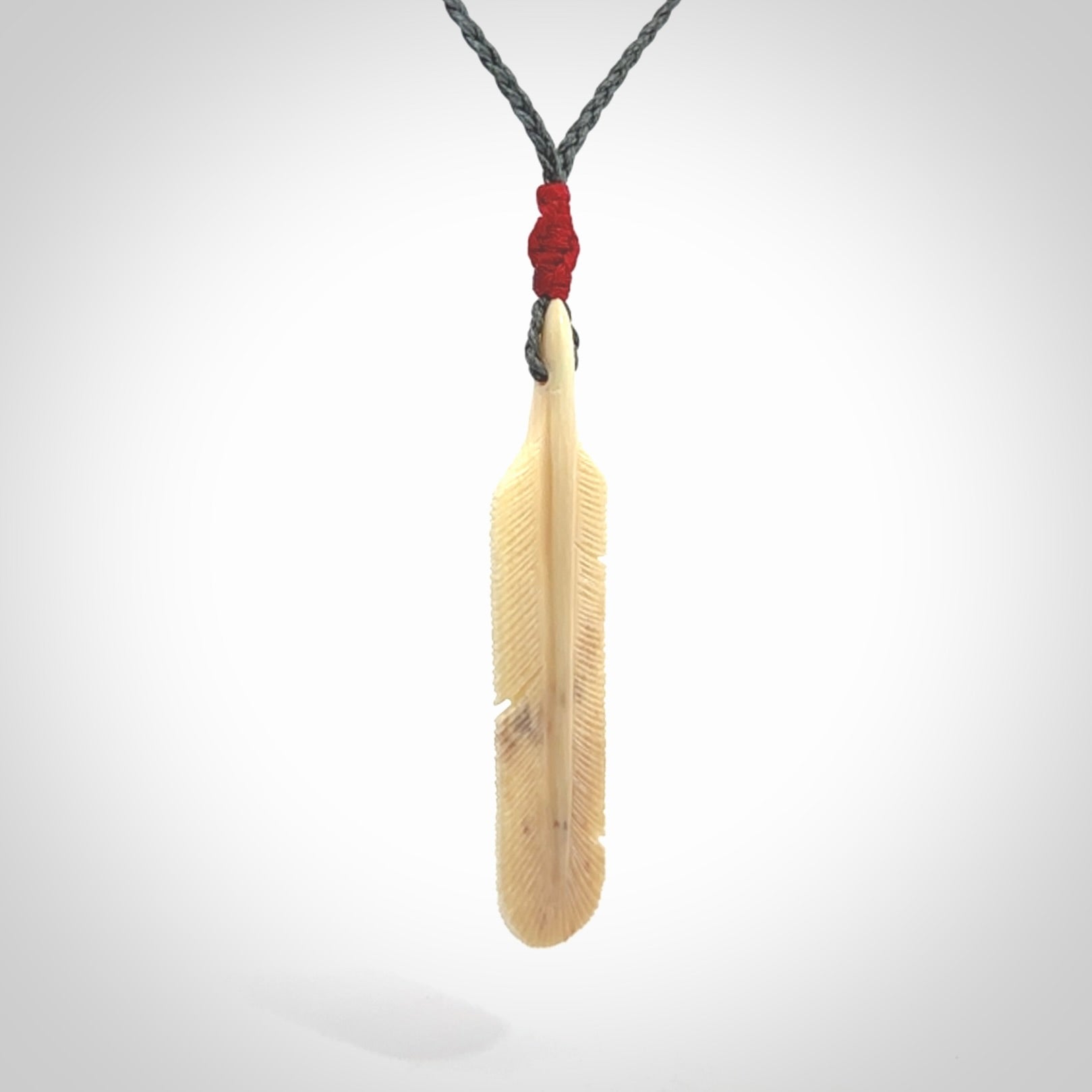 Hand carved Woolly Mammoth Tusk feather pendant. Art to Wear. Provided with adjustable cord.