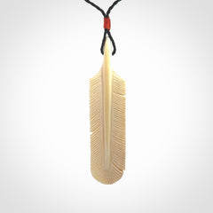 Hand carved Woolly Mammoth Tusk feather pendant. Art to Wear. Provided with adjustable cord.