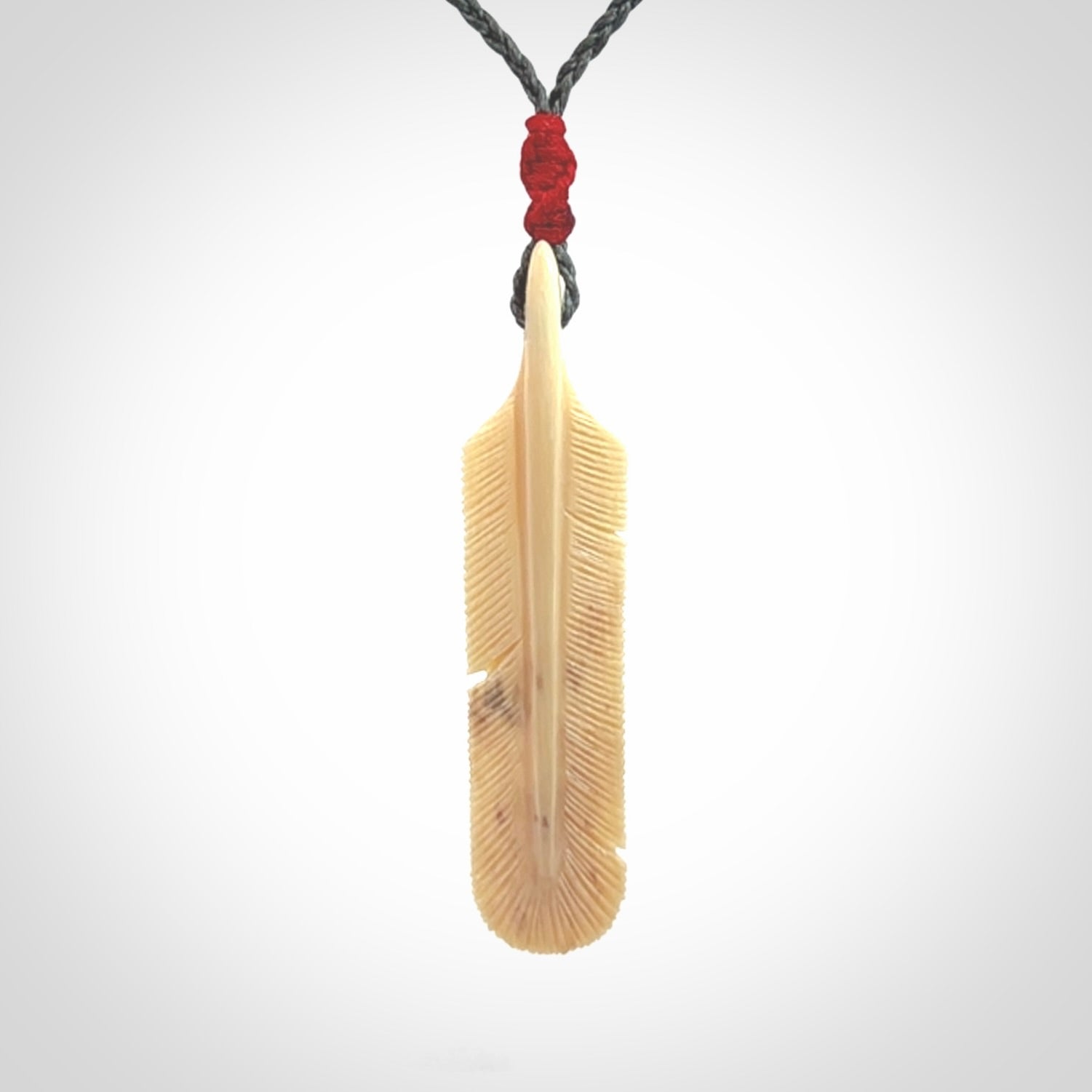 Hand carved Woolly Mammoth Tusk feather pendant. Art to Wear. Provided with adjustable cord.