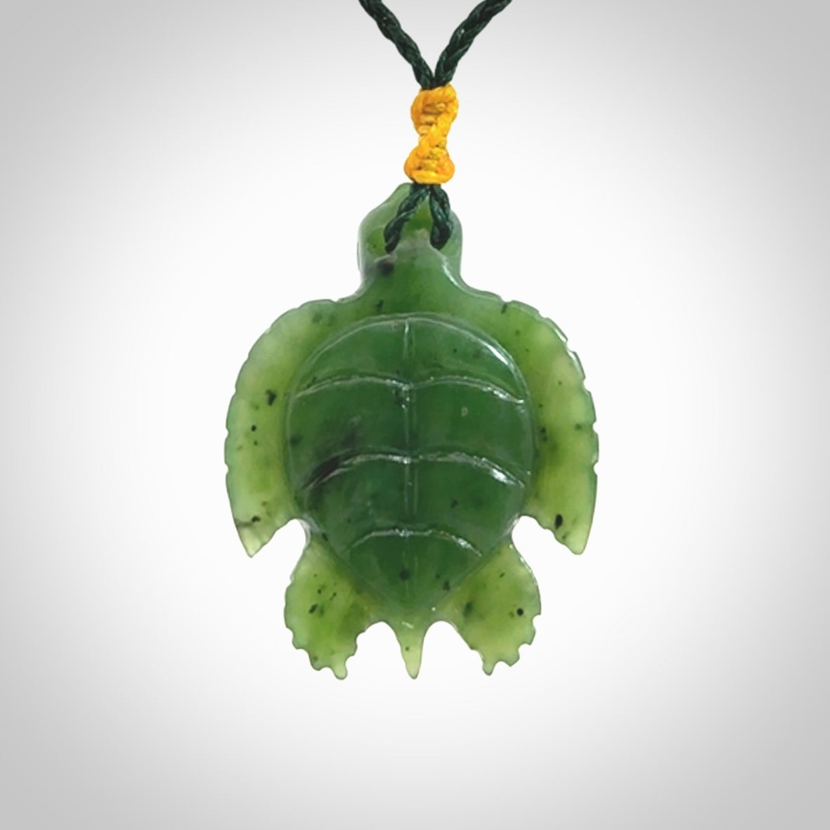 British Columbian jade turtle pendant. Hand carved jade turtle pendant, made by NZ Pacific for sale online. Unique handmade jewellery. Provided with an adjustable cord and packaged in a woven kete pouch.