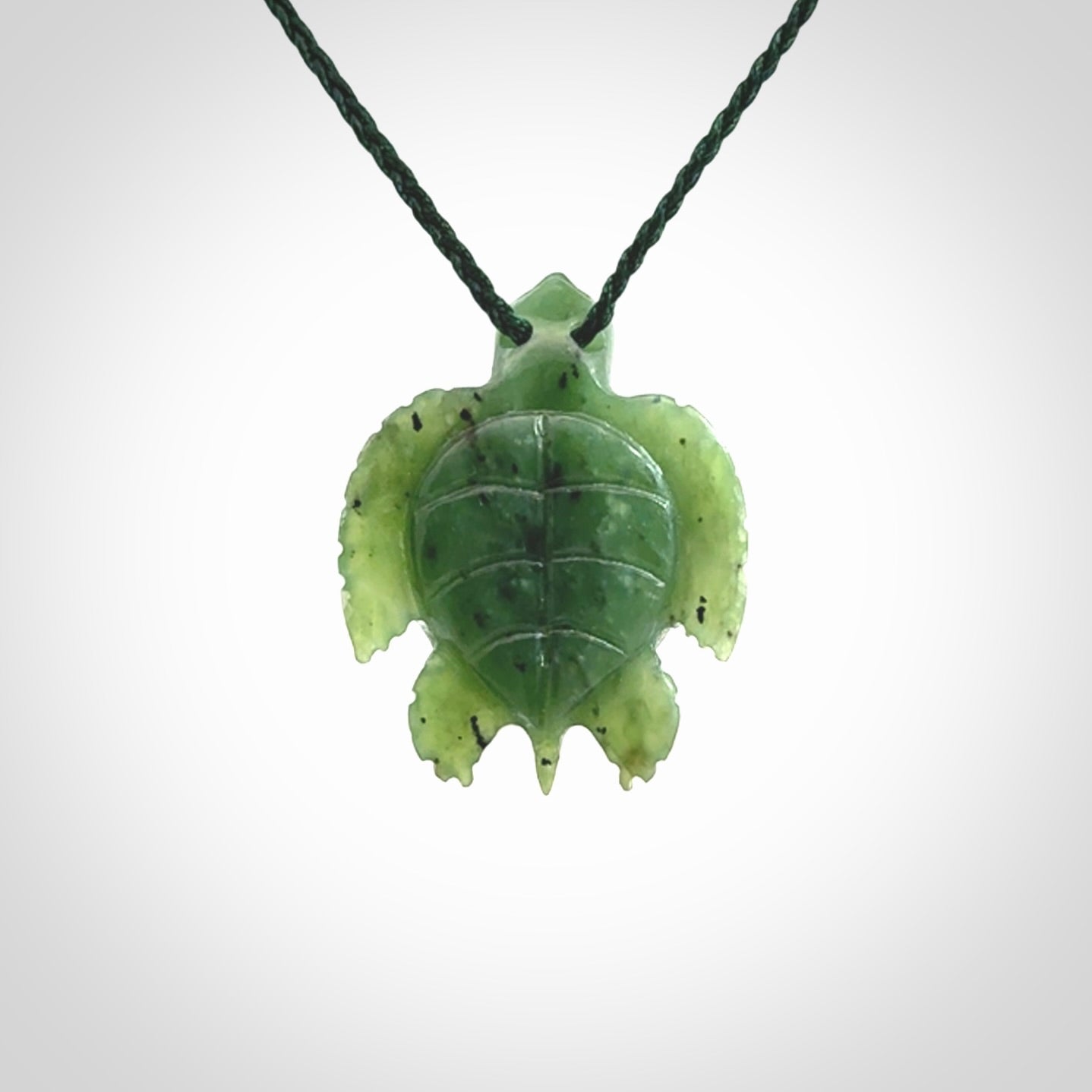 British Columbian jade turtle pendant. Hand carved jade turtle pendant, made by NZ Pacific for sale online. Unique handmade jewellery. Provided with an adjustable cord and packaged in a woven kete pouch.