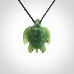 British Columbian jade turtle pendant. Hand carved jade turtle pendant, made by NZ Pacific for sale online. Unique handmade jewellery. Provided with an adjustable cord and packaged in a woven kete pouch.