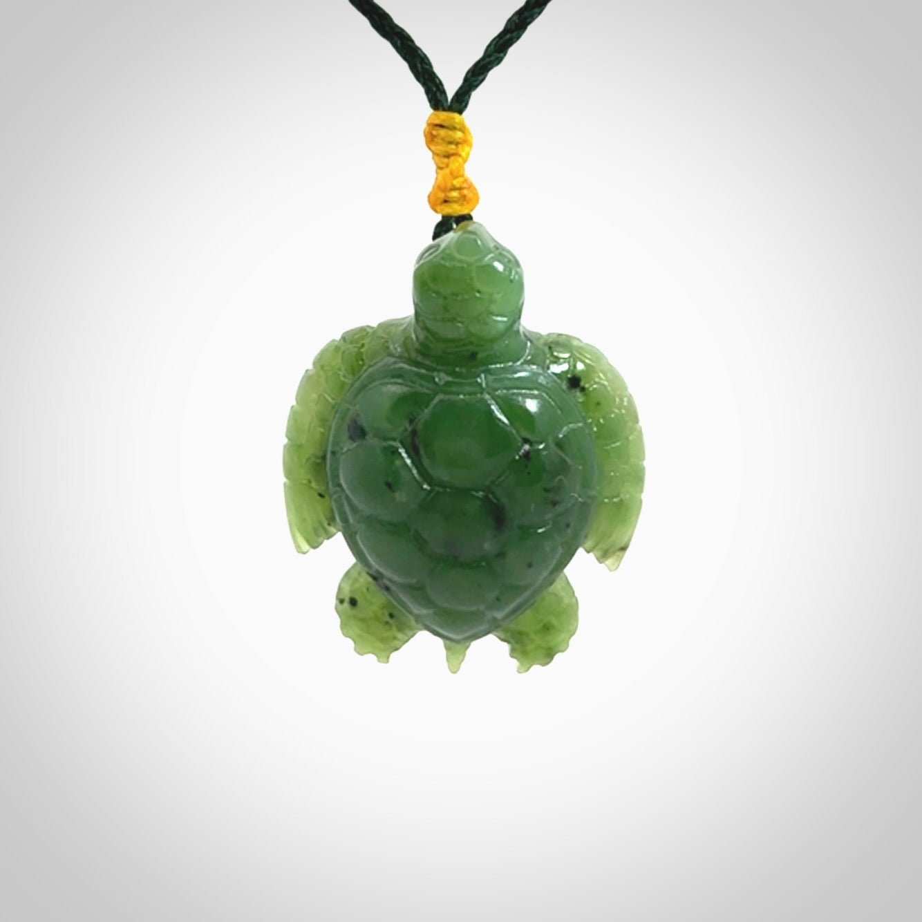 British Columbian jade turtle pendant. Hand carved jade turtle pendant, made by NZ Pacific for sale online. Unique handmade jewellery. Provided with an adjustable cord and packaged in a woven kete pouch.