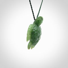 British Columbian jade turtle pendant. Hand carved jade turtle pendant, made by NZ Pacific for sale online. Unique handmade jewellery. Provided with an adjustable cord and packaged in a woven kete pouch.