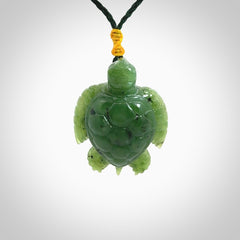 British Columbian jade turtle pendant. Hand carved jade turtle pendant, made by NZ Pacific for sale online. Unique handmade jewellery. Provided with an adjustable cord and packaged in a woven kete pouch.