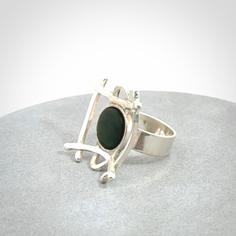 This is a handcrafted New Zealand Pounamu, Jade and sterling silver ring.