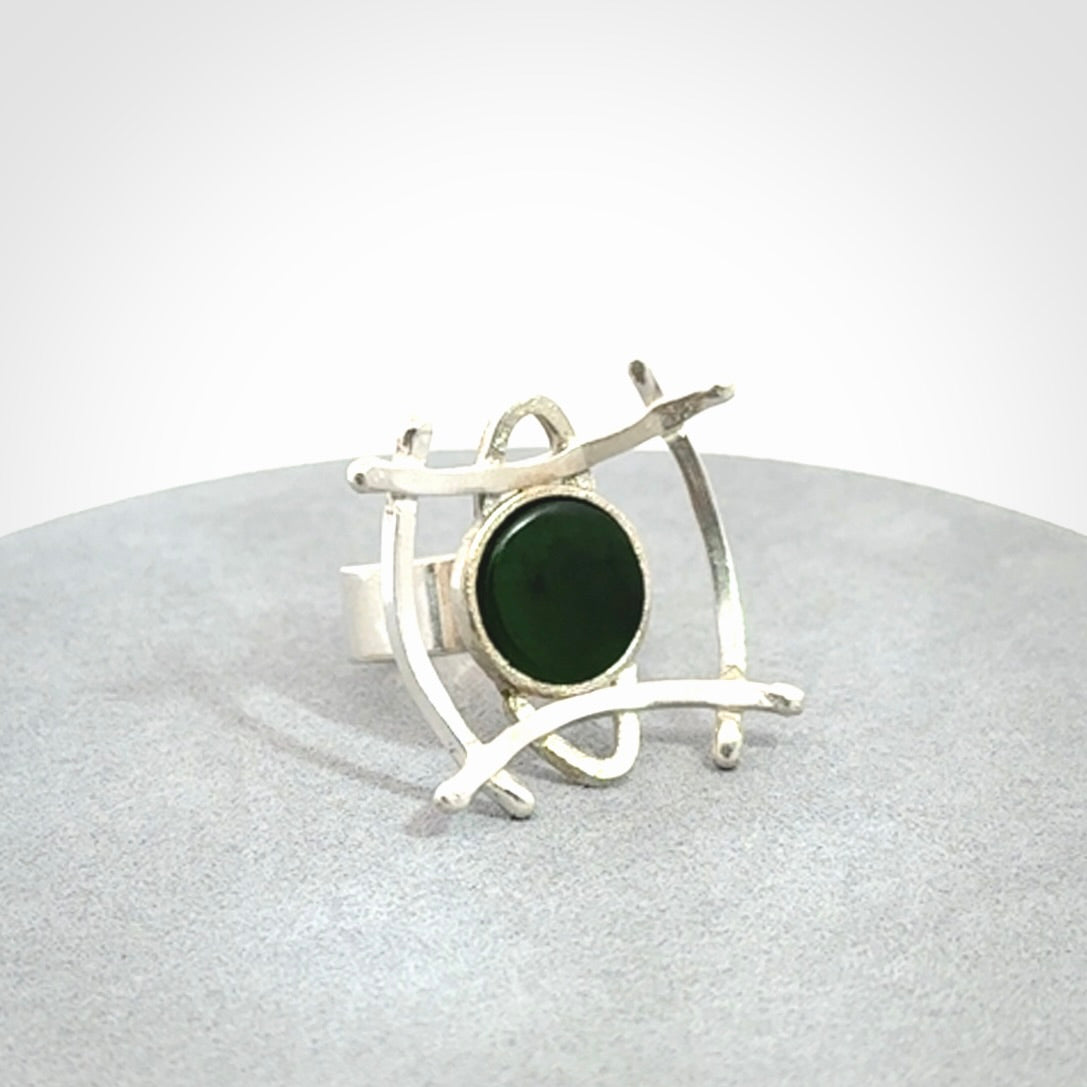 This is a handcrafted New Zealand Pounamu, Jade and sterling silver ring.