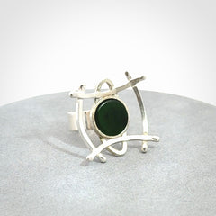 This is a handcrafted New Zealand Pounamu, Jade and sterling silver ring.