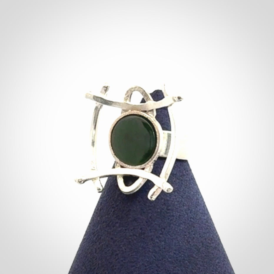 This is a handcrafted New Zealand Pounamu, Jade and sterling silver ring.