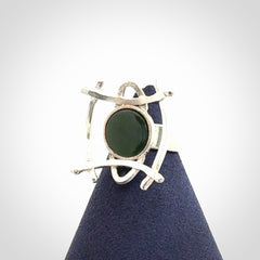 This is a handcrafted New Zealand Pounamu, Jade and sterling silver ring.