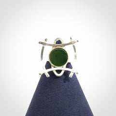 This is a handcrafted New Zealand Pounamu, Jade and sterling silver ring.