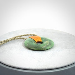 This is a hand carved disc pendant. Graeme carved this from Nephrite Jade. It is a gorgeous green colour and is an artistic piece of jewellery. Hand made by Graeme Wylie and delivered to you in a kete pouch.