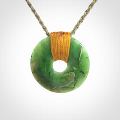 This is a hand carved disc pendant. Graeme carved this from Nephrite Jade. It is a gorgeous green colour and is an artistic piece of jewellery. Hand made by Graeme Wylie and delivered to you in a kete pouch.
