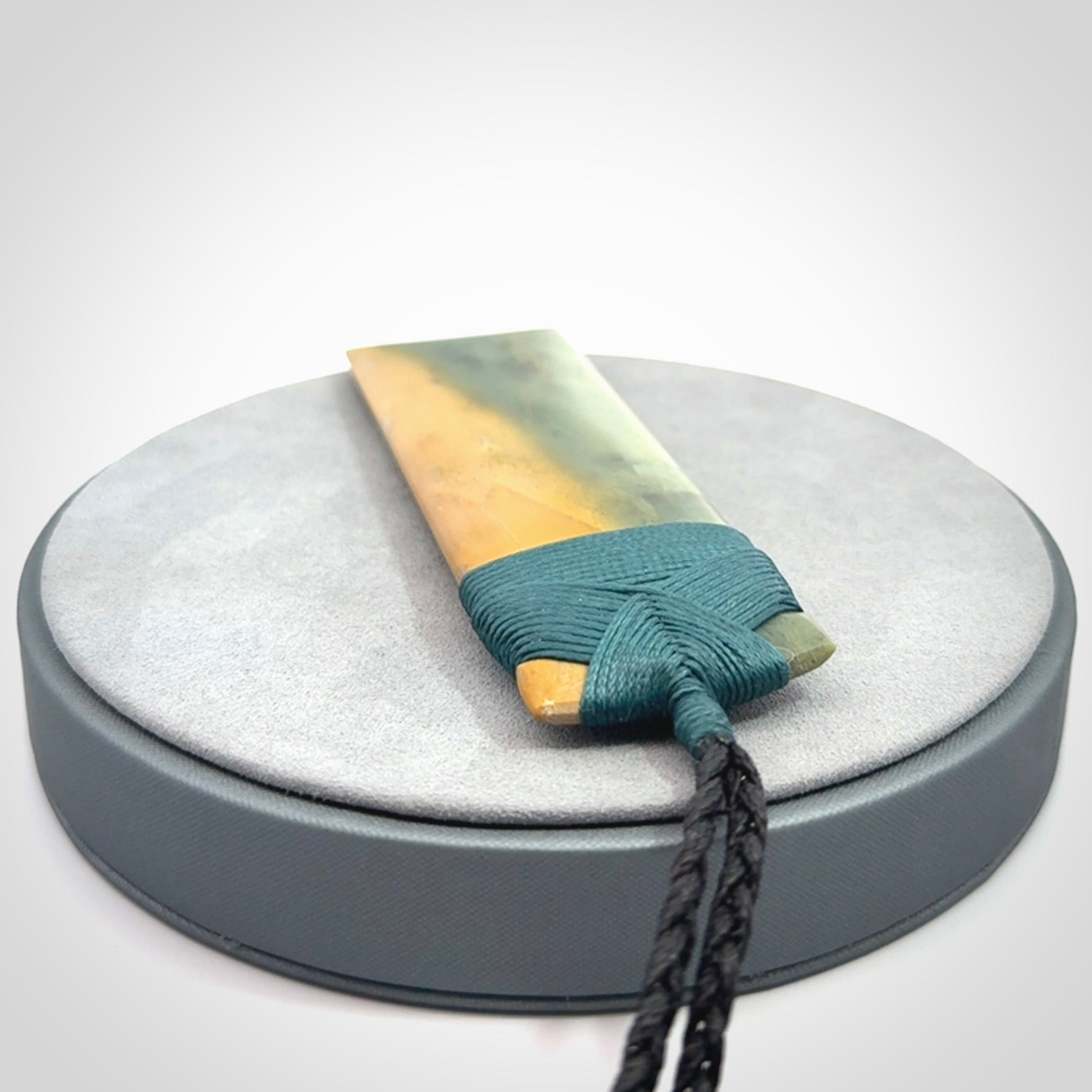 This is a lovely, one-off large, green toki pendant we've made from a gorgeous New Zealand jade. It is finished in a matte sheen and is bound with our plaited cord. These are wonderful pieces that are very attractive and will last a lifetime.
