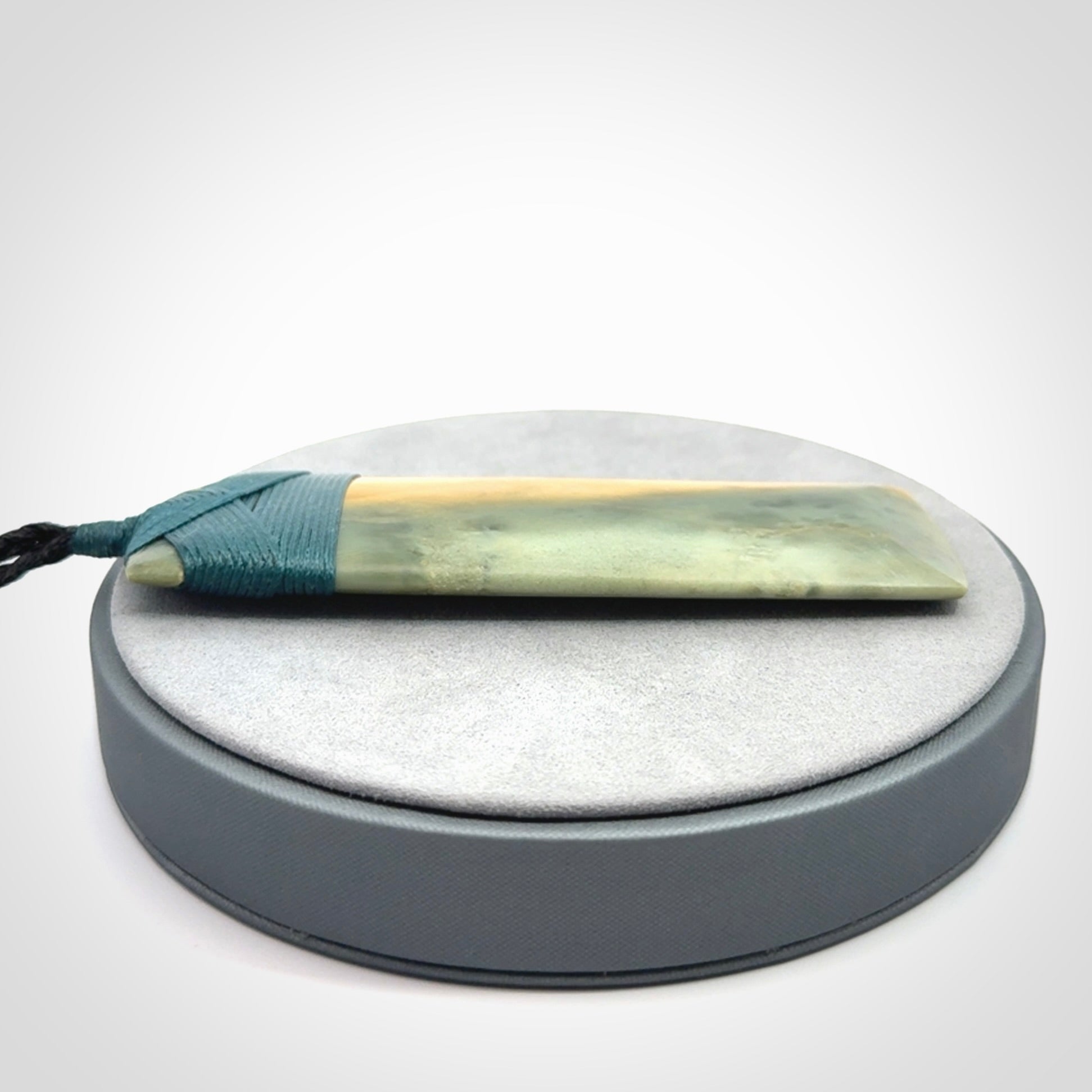 This is a lovely, one-off large, green toki pendant we've made from a gorgeous New Zealand jade. It is finished in a matte sheen and is bound with our plaited cord. These are wonderful pieces that are very attractive and will last a lifetime.