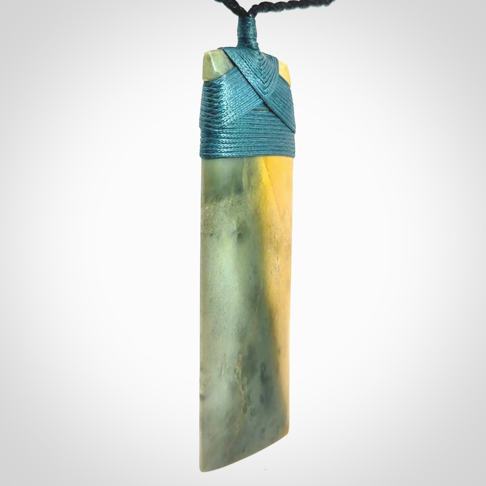 This is a lovely, one-off large, green toki pendant we've made from a gorgeous New Zealand jade. It is finished in a matte sheen and is bound with our plaited cord. These are wonderful pieces that are very attractive and will last a lifetime.