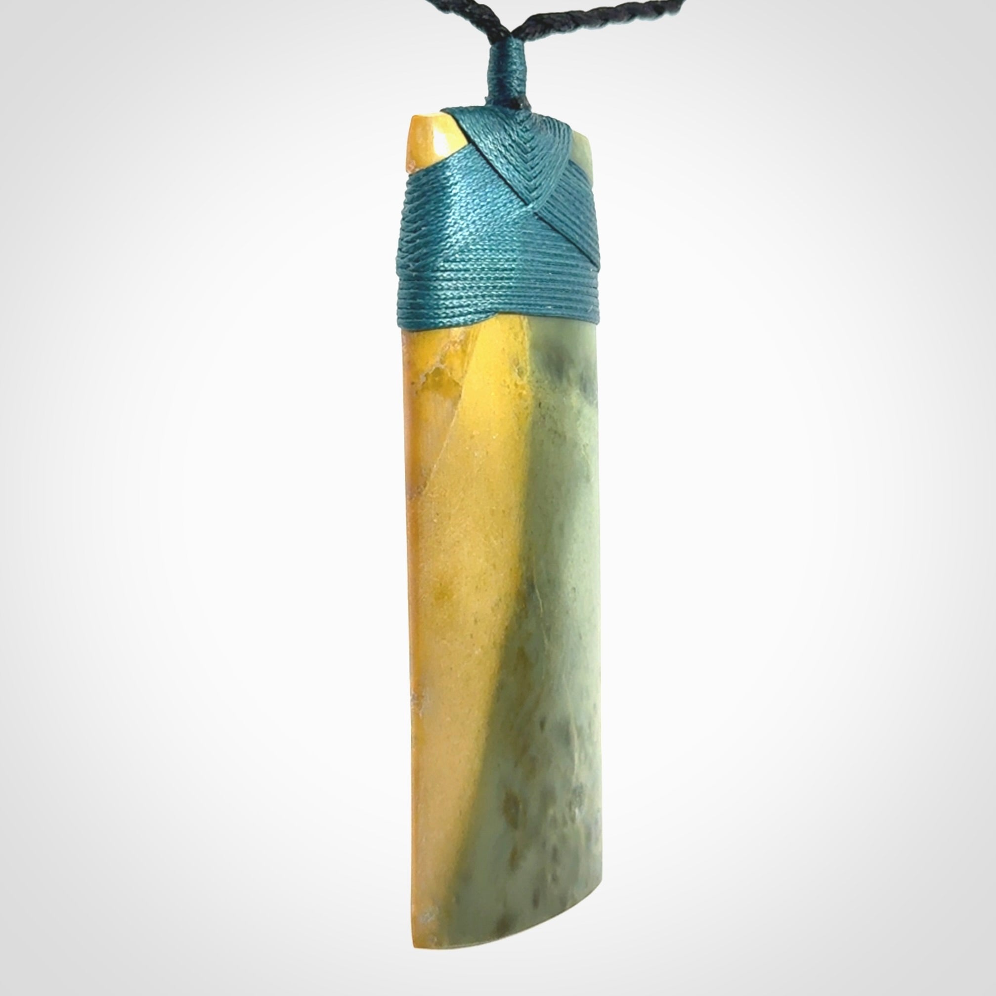 This is a lovely, one-off large, green toki pendant we've made from a gorgeous New Zealand jade. It is finished in a matte sheen and is bound with our plaited cord. These are wonderful pieces that are very attractive and will last a lifetime.