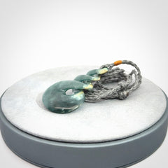 This is a hand carved triple twist pendant. Graeme carved this from Guatemalan Jadeite. It is a gorgeous blue colour and is an artistic piece of jewellery. Hand made by Graeme Wylie and delivered to you in a kete pouch.