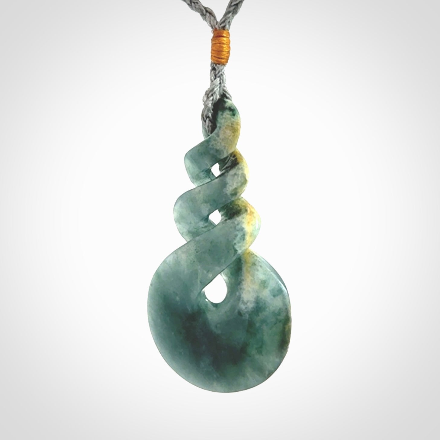 This is a hand carved triple twist pendant. Graeme carved this from Guatemalan Jadeite. It is a gorgeous blue colour and is an artistic piece of jewellery. Hand made by Graeme Wylie and delivered to you in a kete pouch.
