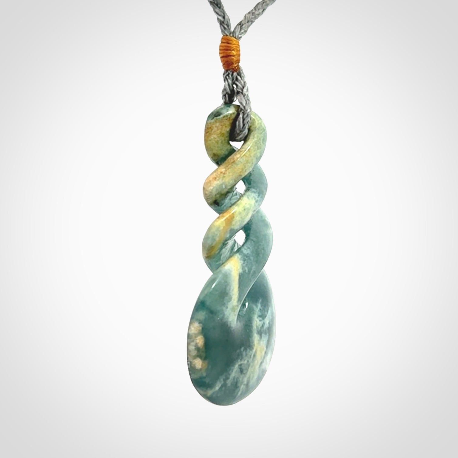 This is a hand carved triple twist pendant. Graeme carved this from Guatemalan Jadeite. It is a gorgeous blue colour and is an artistic piece of jewellery. Hand made by Graeme Wylie and delivered to you in a kete pouch.