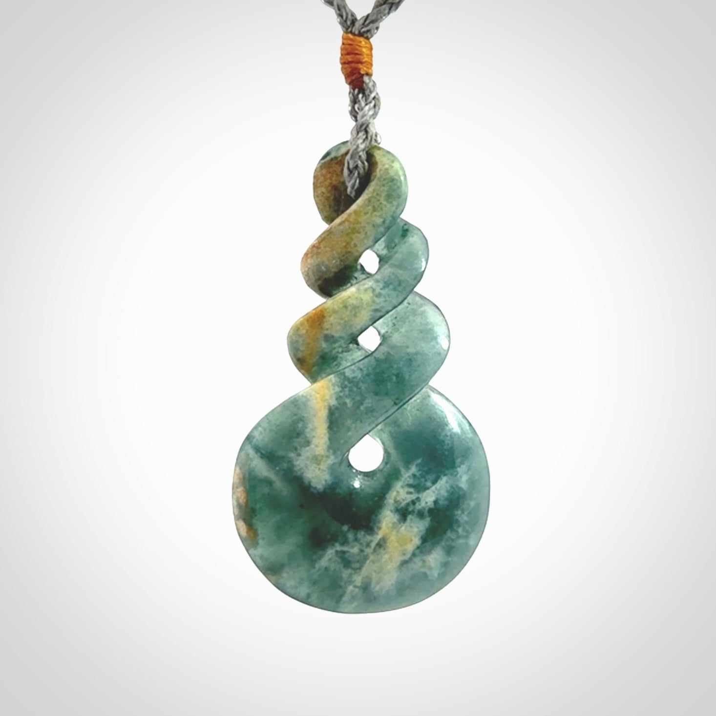 This is a hand carved triple twist pendant. Graeme carved this from Guatemalan Jadeite. It is a gorgeous blue colour and is an artistic piece of jewellery. Hand made by Graeme Wylie and delivered to you in a kete pouch.