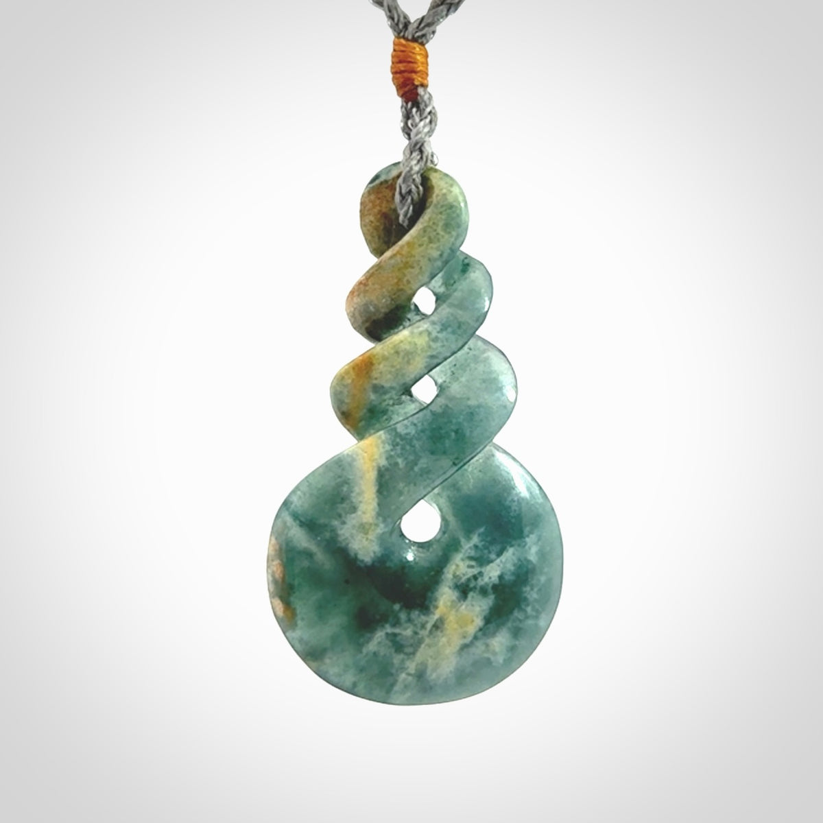 This is a hand carved triple twist pendant. Graeme carved this from Guatemalan Jadeite. It is a gorgeous blue colour and is an artistic piece of jewellery. Hand made by Graeme Wylie and delivered to you in a kete pouch.
