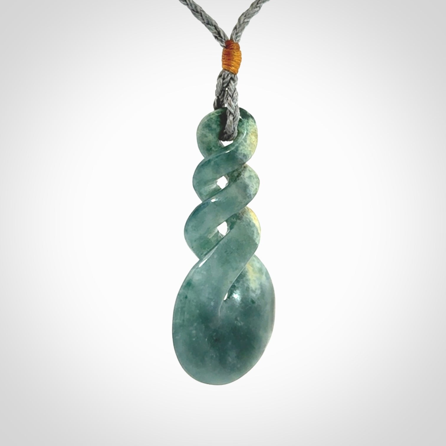 This is a hand carved triple twist pendant. Graeme carved this from Guatemalan Jadeite. It is a gorgeous blue colour and is an artistic piece of jewellery. Hand made by Graeme Wylie and delivered to you in a kete pouch.