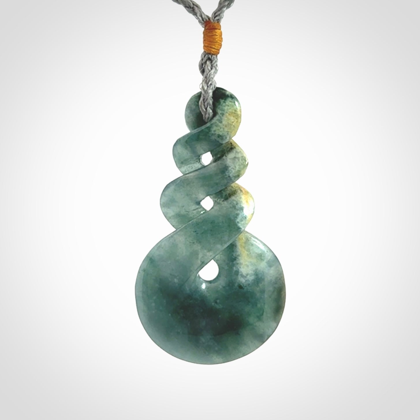 This is a hand carved triple twist pendant. Graeme carved this from Guatemalan Jadeite. It is a gorgeous blue colour and is an artistic piece of jewellery. Hand made by Graeme Wylie and delivered to you in a kete pouch.