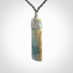 This is a hand carved toki pendant. Graeme carved this from Guatemalan Jadeite. It is a gorgeous blue colour and is an artistic piece of jewellery. Hand made by Graeme Wylie and delivered to you in a kete pouch.