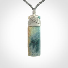 This is a hand carved toki pendant. Graeme carved this from Guatemalan Jadeite. It is a gorgeous blue colour and is an artistic piece of jewellery. Hand made by Graeme Wylie and delivered to you in a kete pouch.