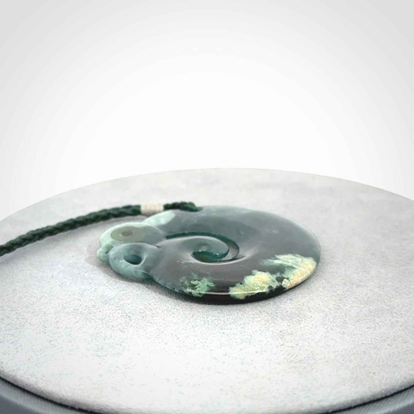 Guatemalan Jadeite Koru Manaia pendant. Made in New Zealand. Real Jade, pounamu. Real New Zealand Jade Manaia with Koru necklace with a polished finish.