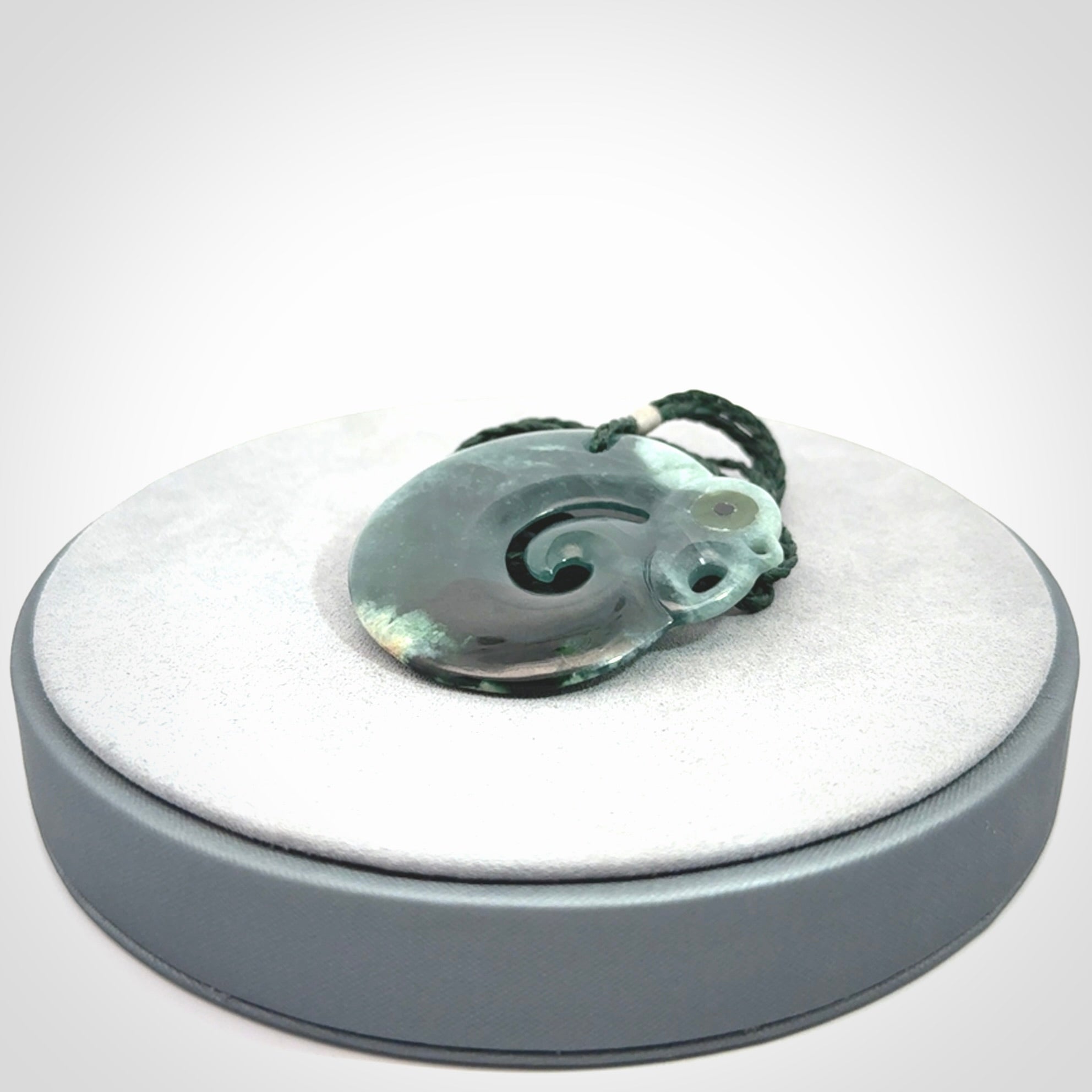 Guatemalan Jadeite Koru Manaia pendant. Made in New Zealand. Real Jade, pounamu. Real New Zealand Jade Manaia with Koru necklace with a polished finish.