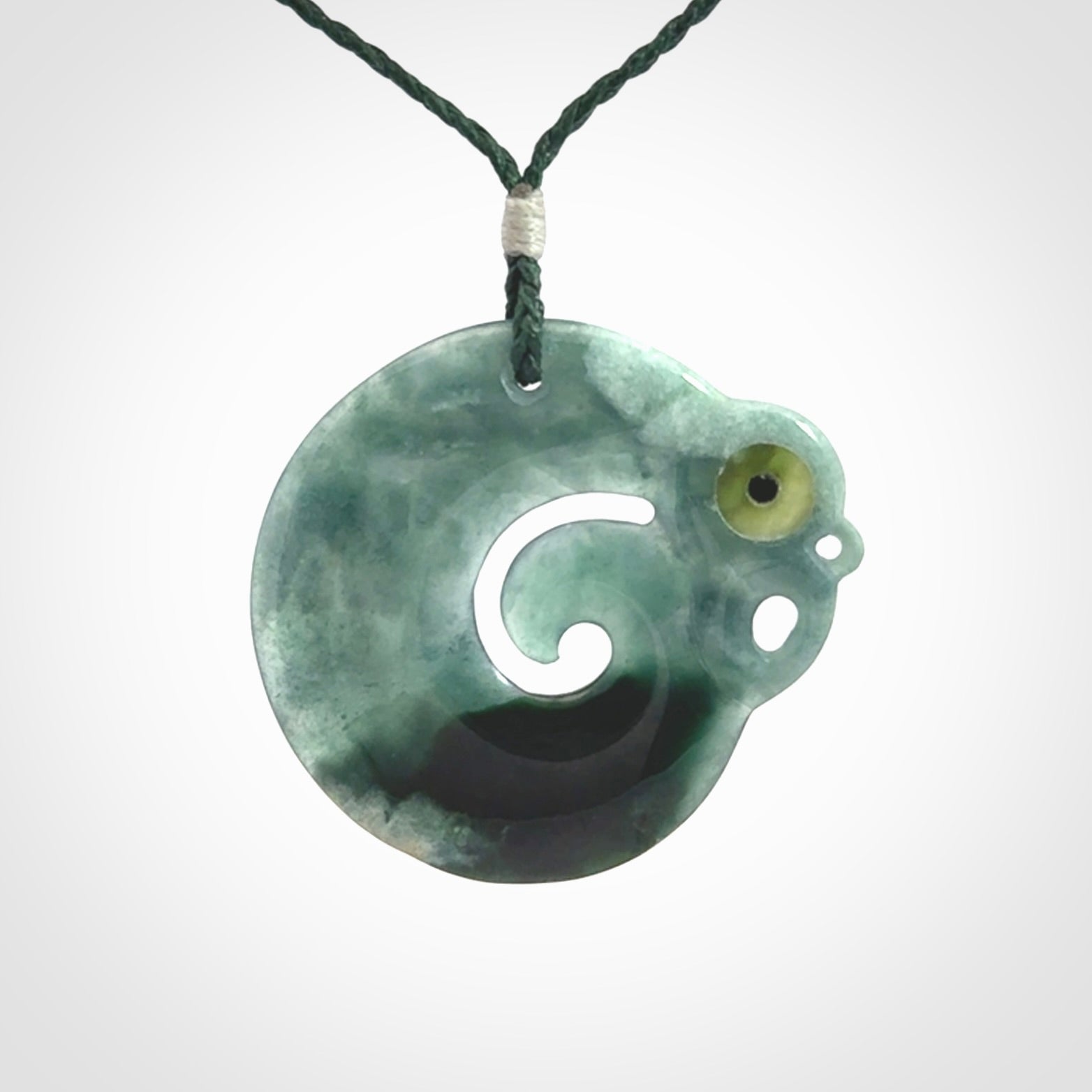 Guatemalan Jadeite Koru Manaia pendant. Made in New Zealand. Real Jade, pounamu. Real New Zealand Jade Manaia with Koru necklace with a polished finish.