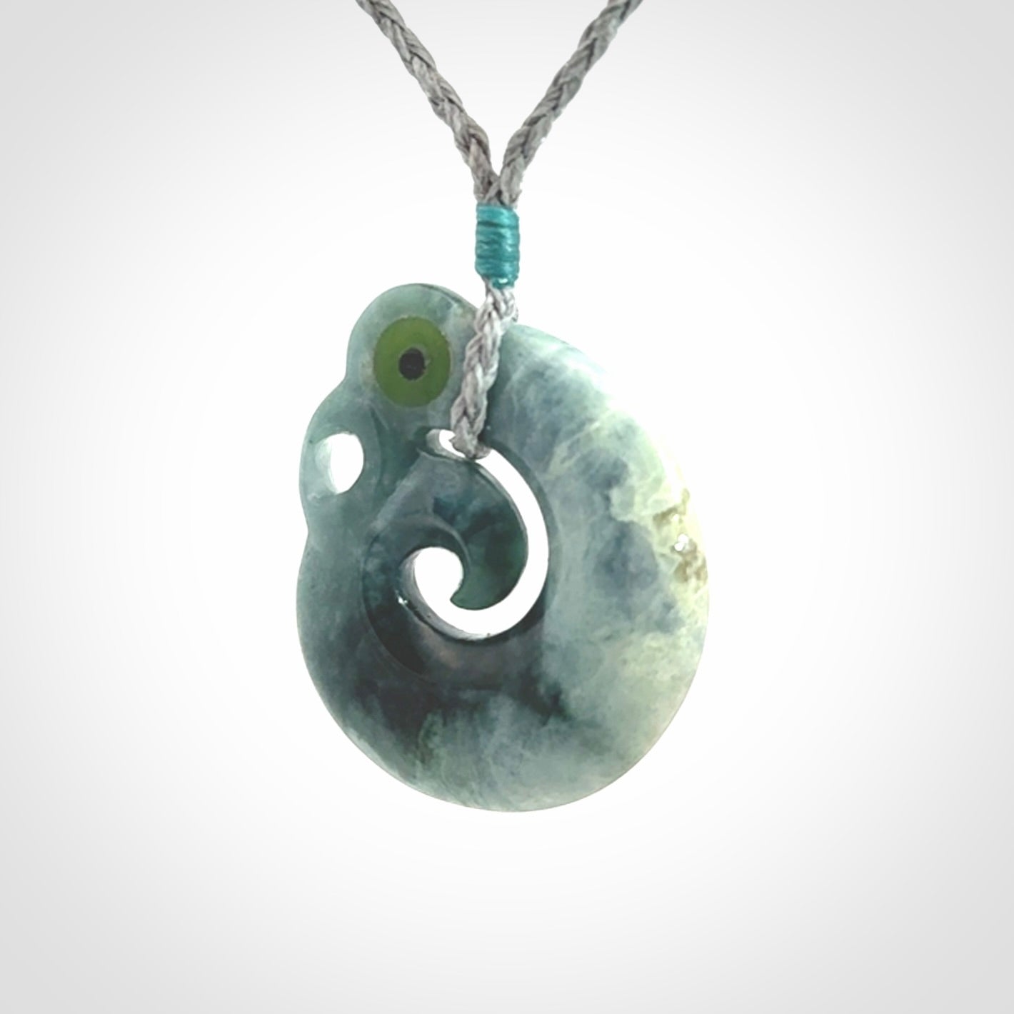 Guatemalan Jadeite Koru Manaia pendant. Made in New Zealand. Real Jade, pounamu. Real New Zealand Jade Manaia with Koru necklace with a polished finish.
