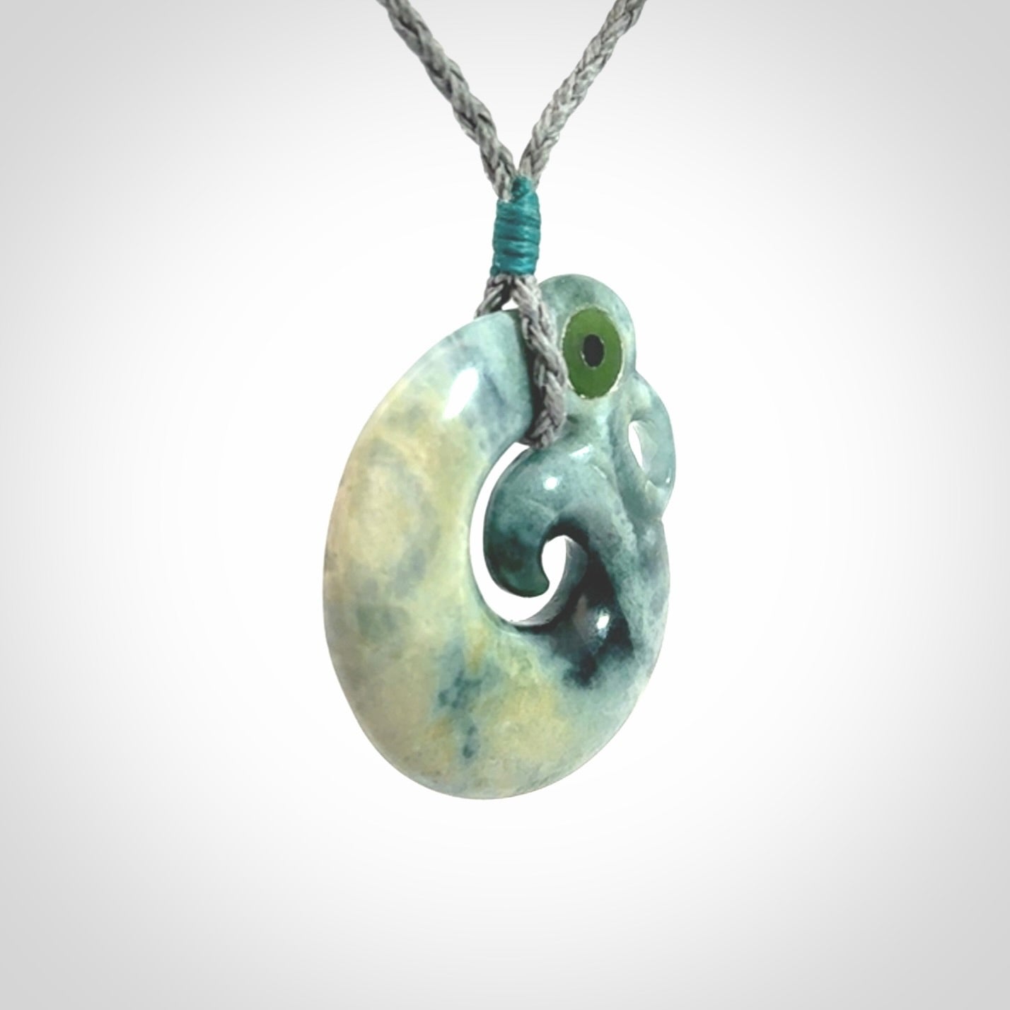 Guatemalan Jadeite Koru Manaia pendant. Made in New Zealand. Real Jade, pounamu. Real New Zealand Jade Manaia with Koru necklace with a polished finish.